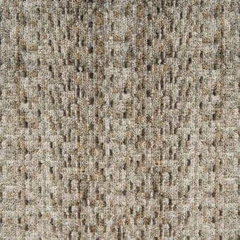 Woven fabric sample, muted gray and golden-brown, displaying a dense, irregular geometric pattern with a matte, nubby texture.